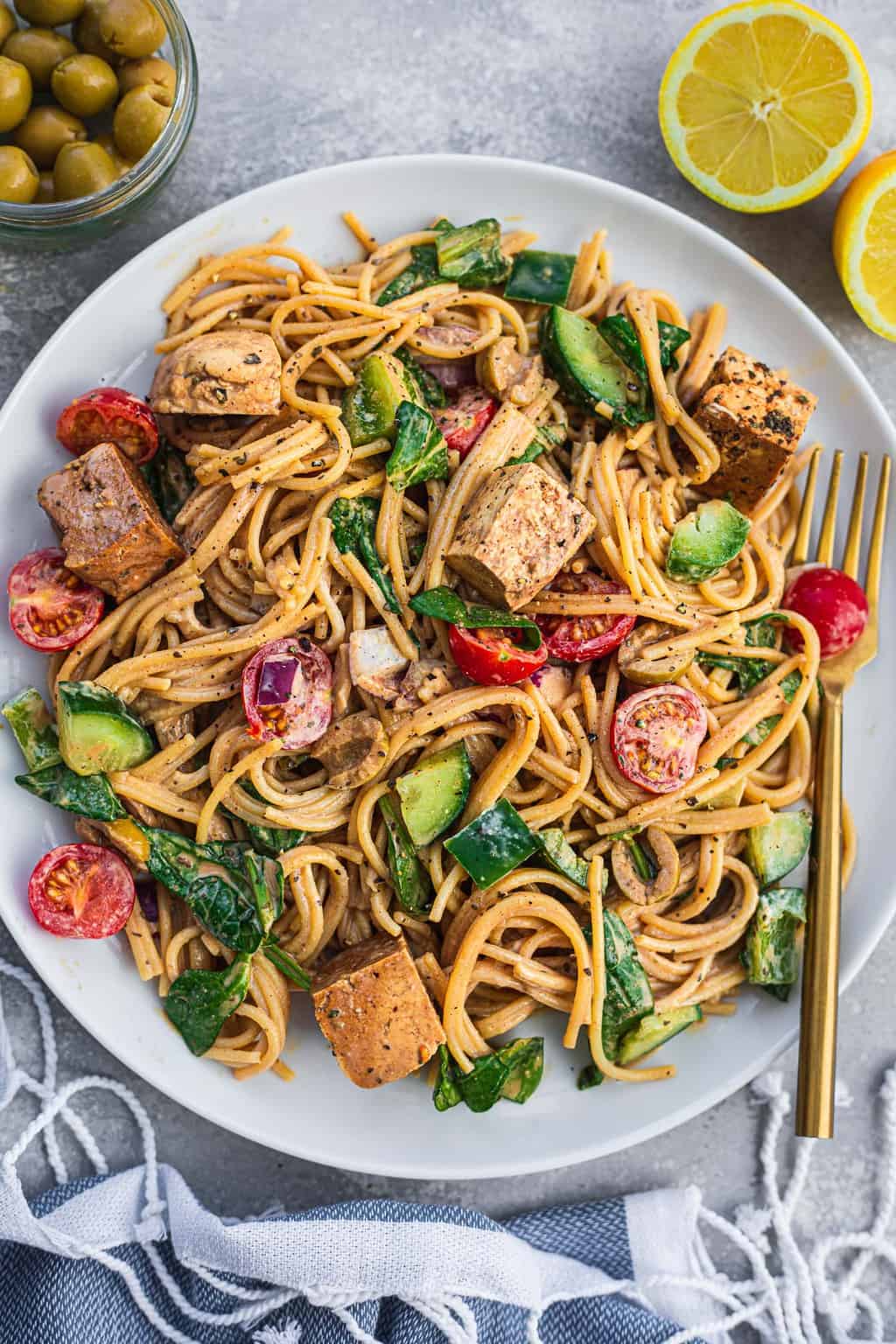 Plate of cold vegan pasta with tofu and vegetables