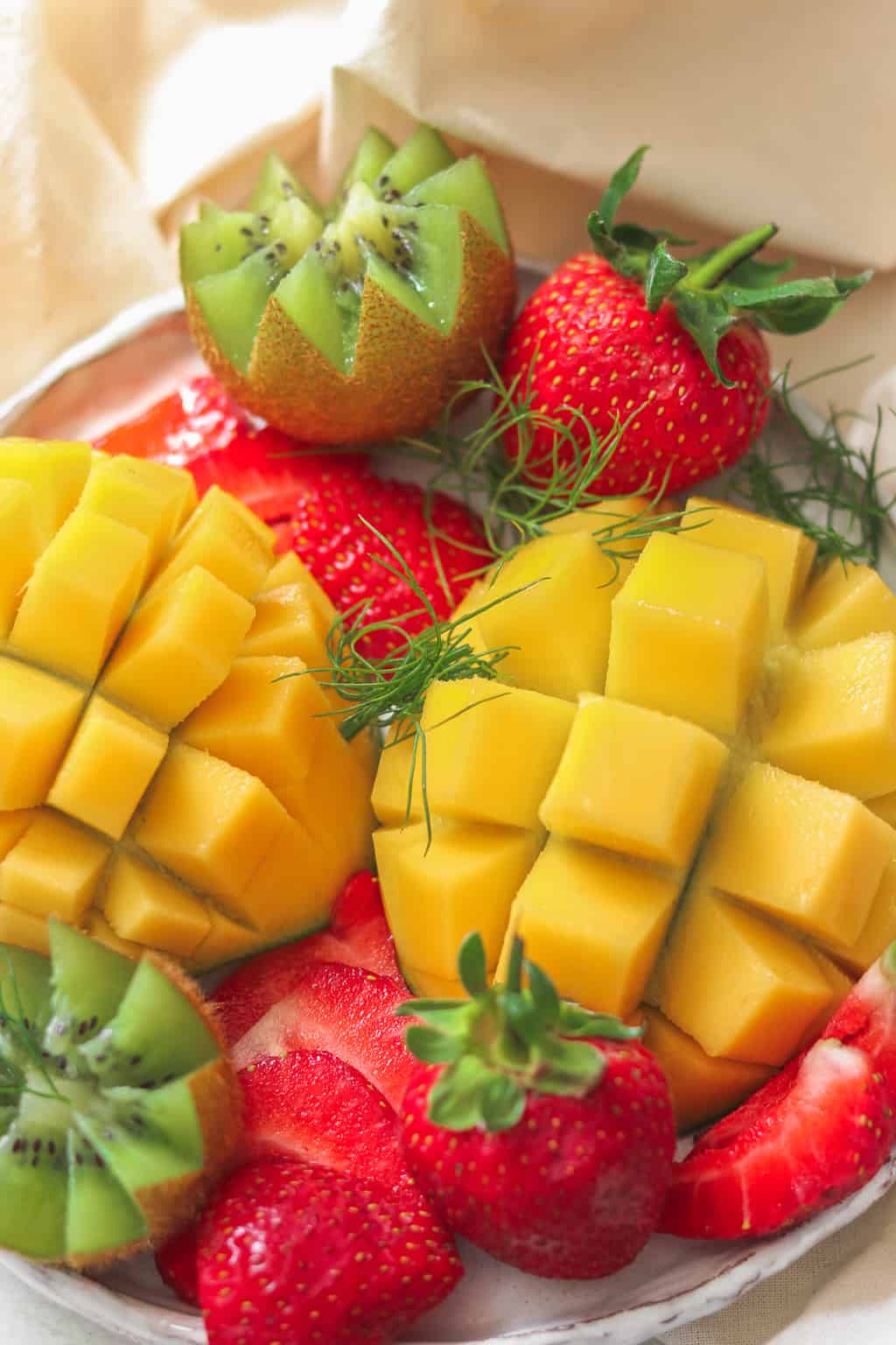 Fruit platter for breakfast with mango, strawberries and kiwi