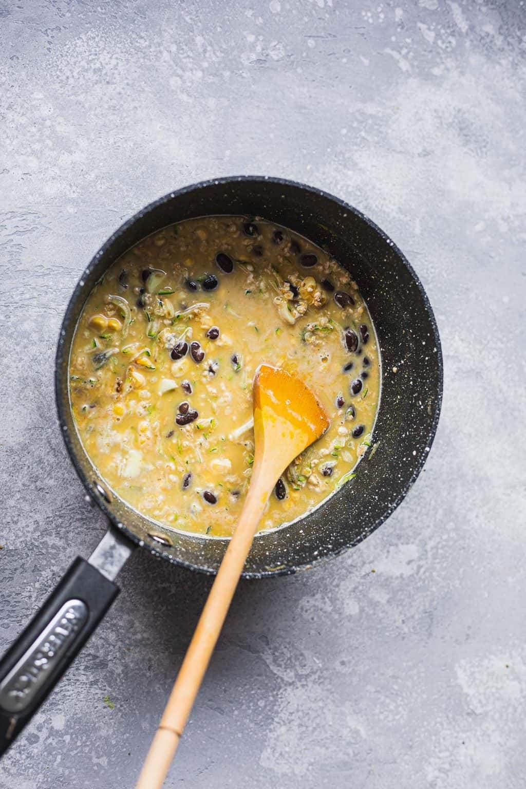 Oats with black beans in a saucepan