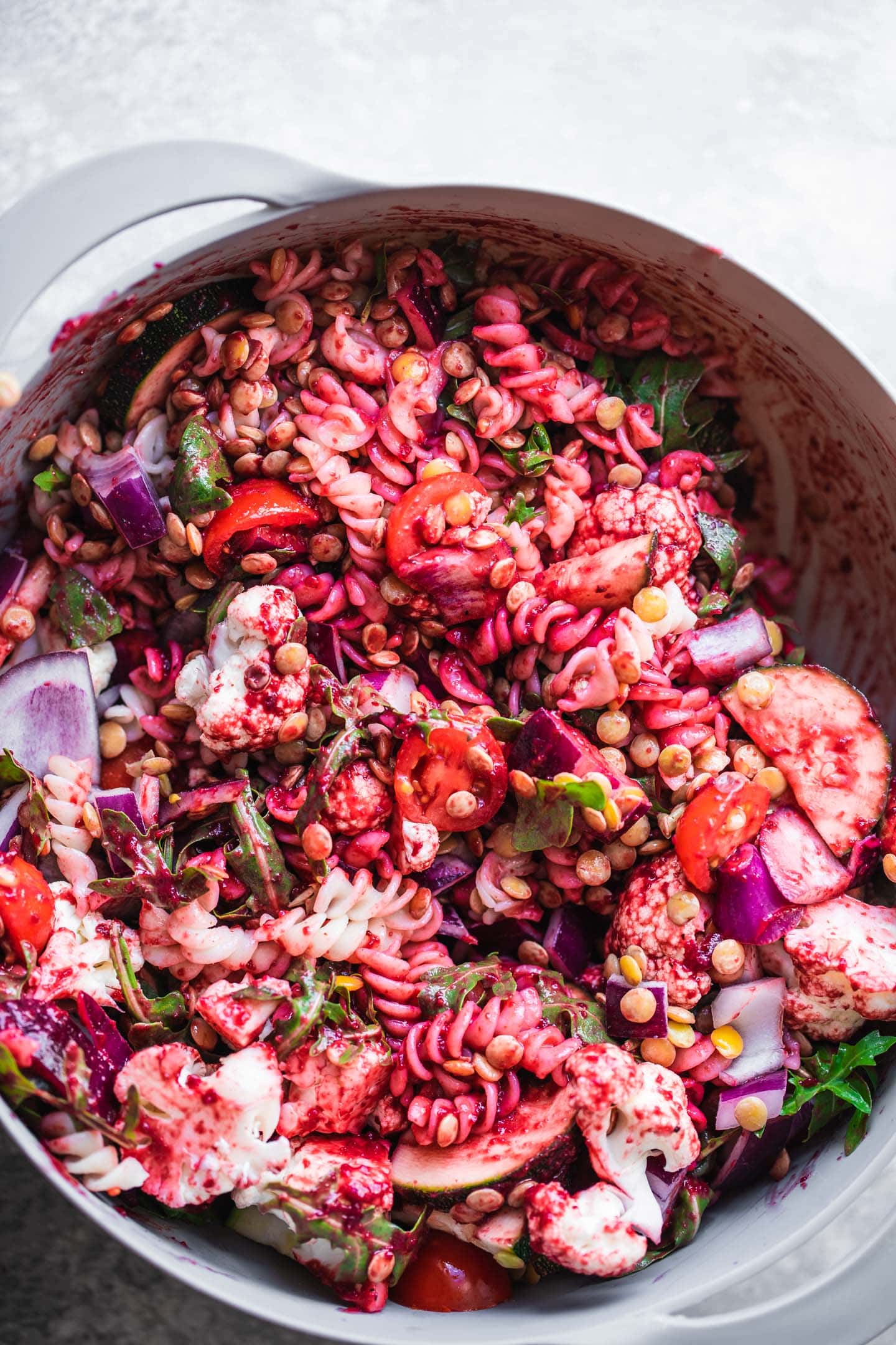 Beetroot pasta salad in a mixing bowl