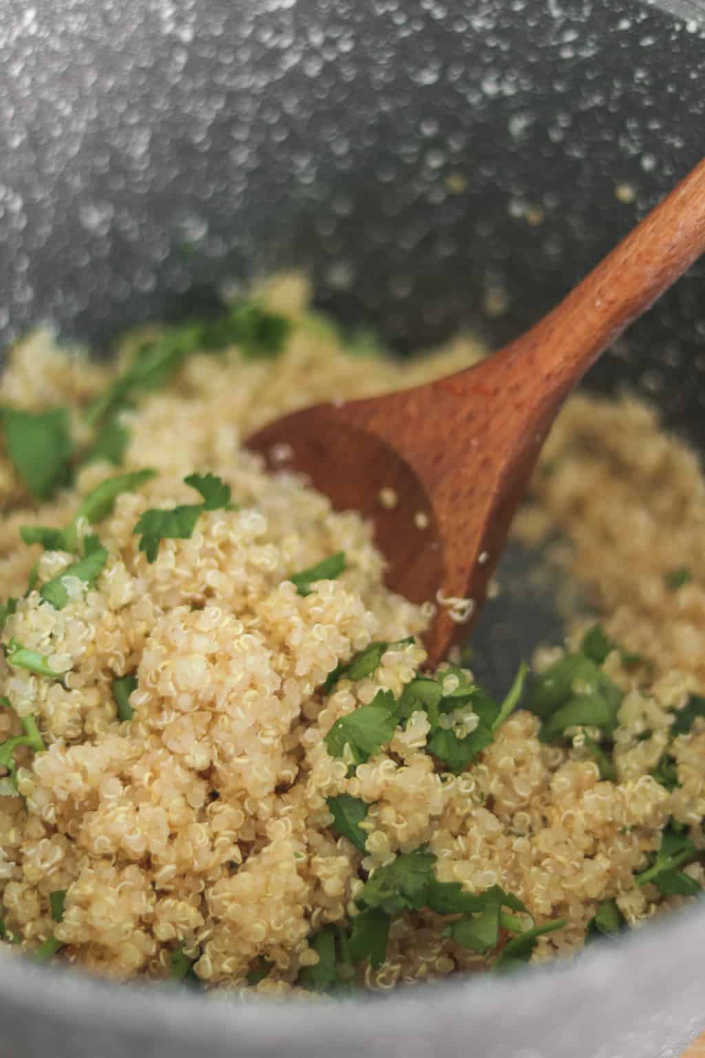 Quinoa with lemon juice and fresh coriander in a saucepan