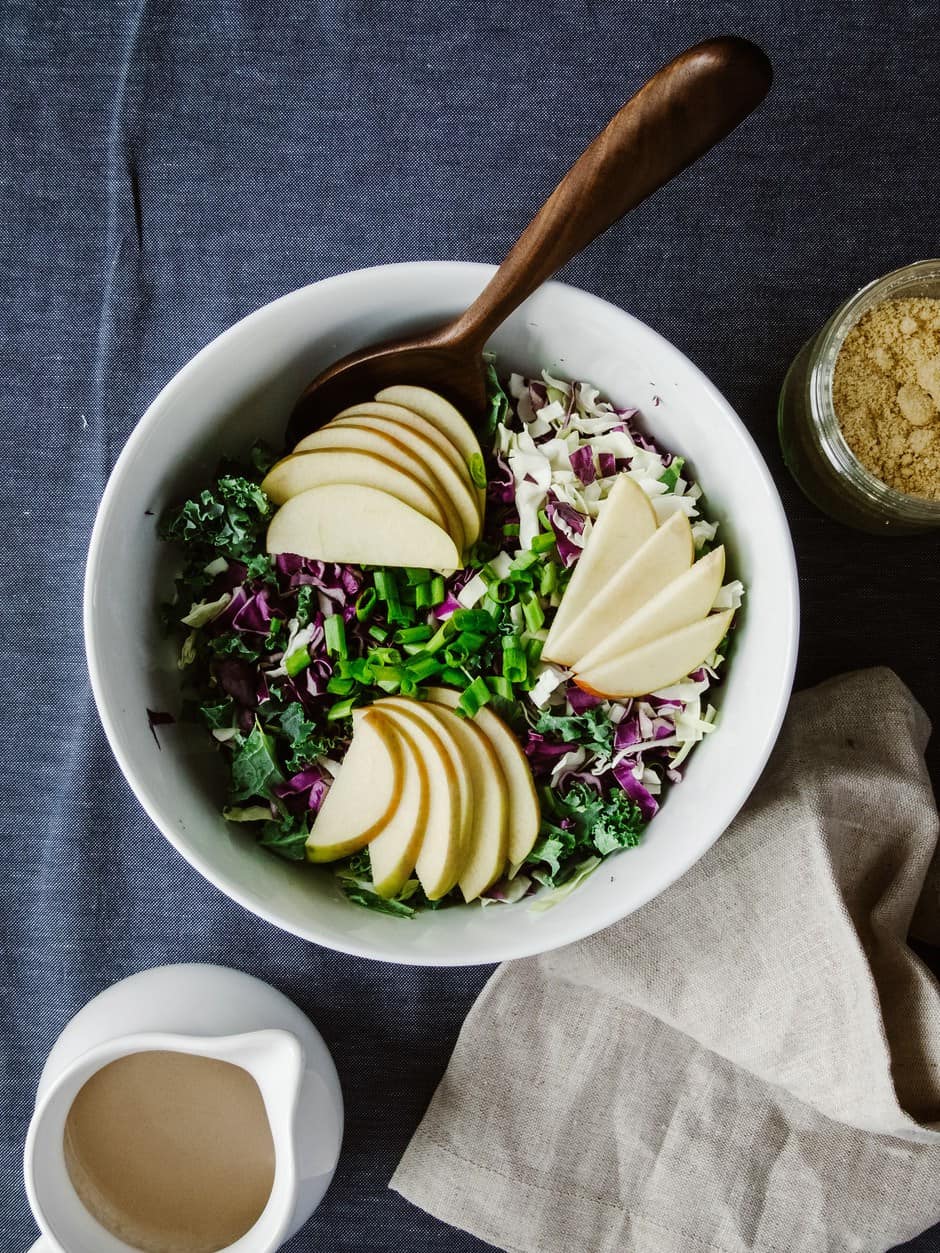Crunchy Apple Kale Slaw With Balsamic Tahini Dressing And Almond Parmesan