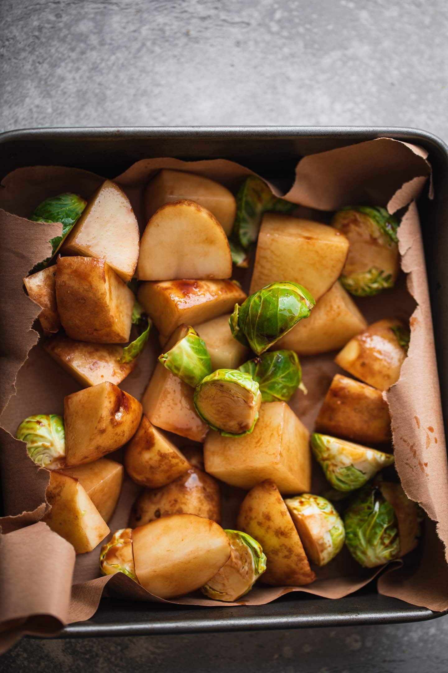 Potatoes and Brussels sprouts in a baking tin