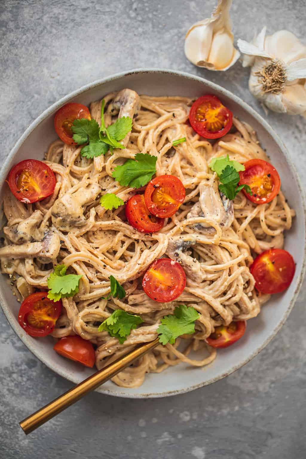 Bowl with pasta in a creamy sauce with tomatoes