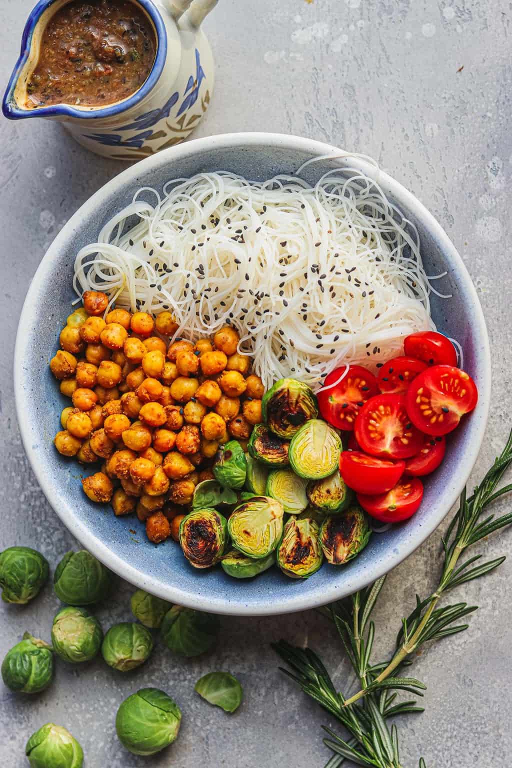 Vegan bowl with chickpeas and noodles and gravy on the side