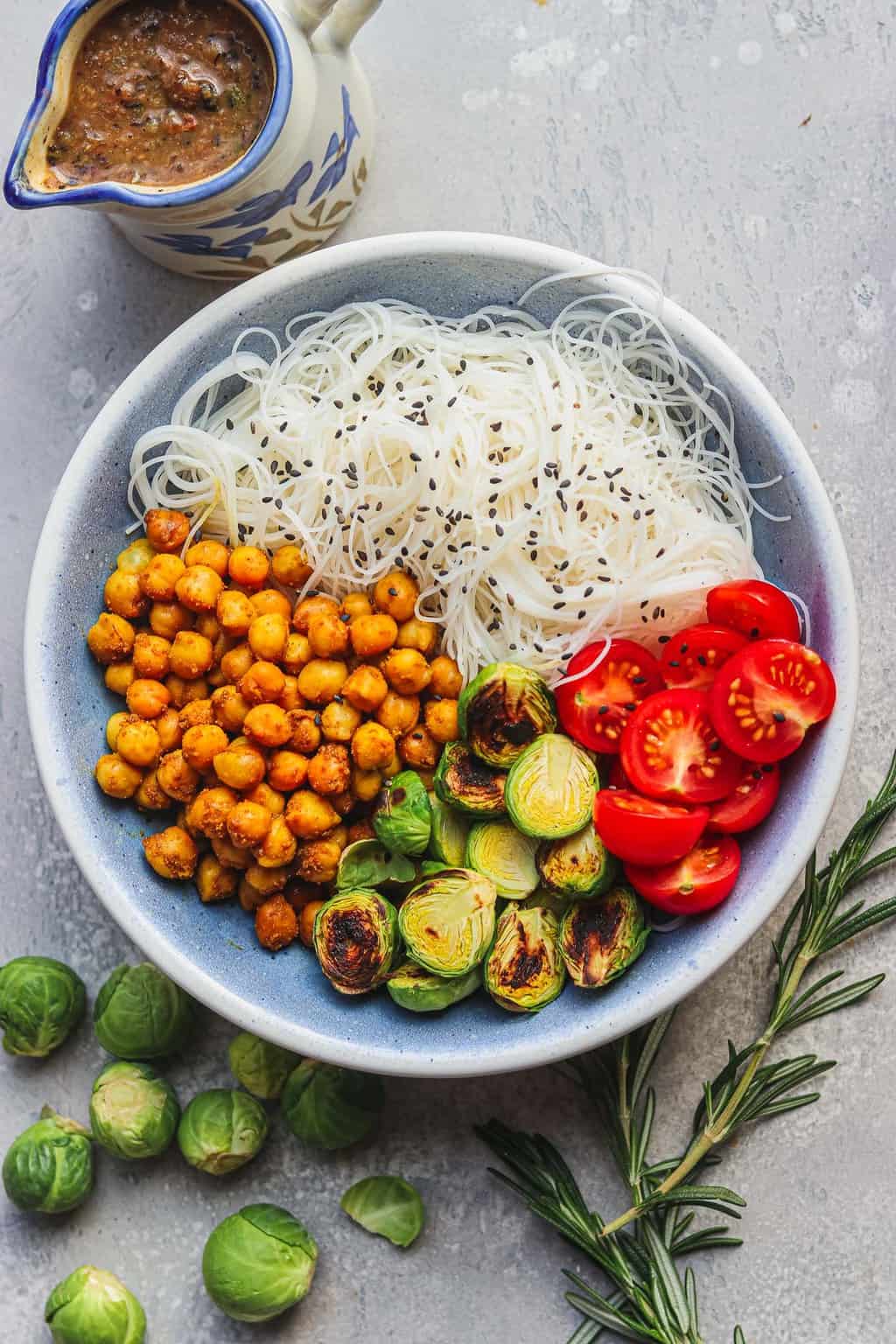 Bowl with chickpeas and noodles and gravy on the side