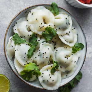 Gluten-free vegan pelmeni with mushrooms and spinach