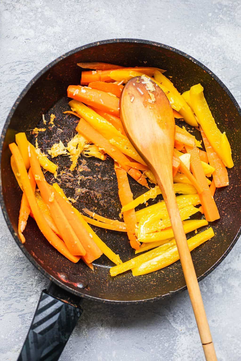 Carrots and bell pepper in a frying pan