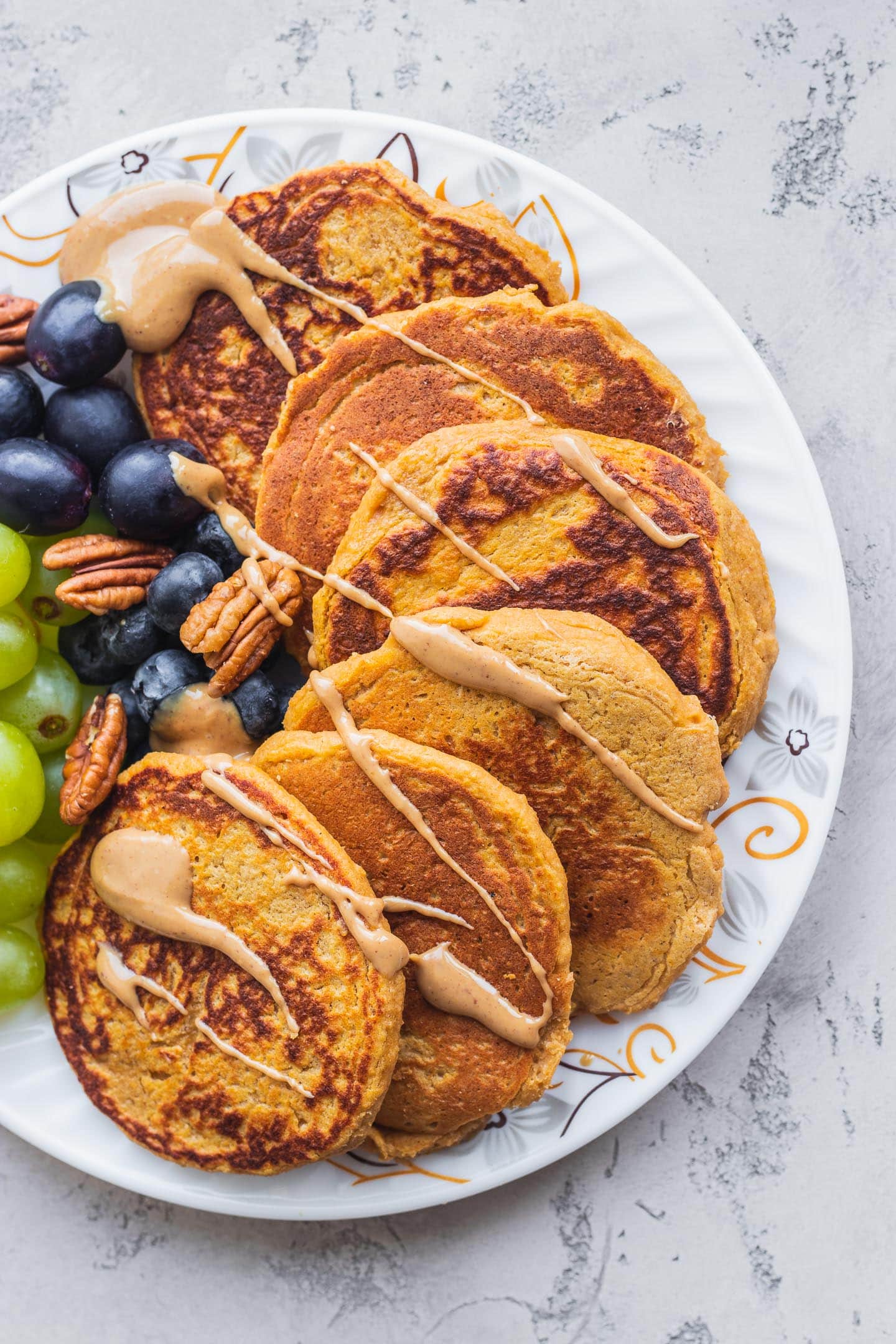 Pancakes on a white plate with peanut butter