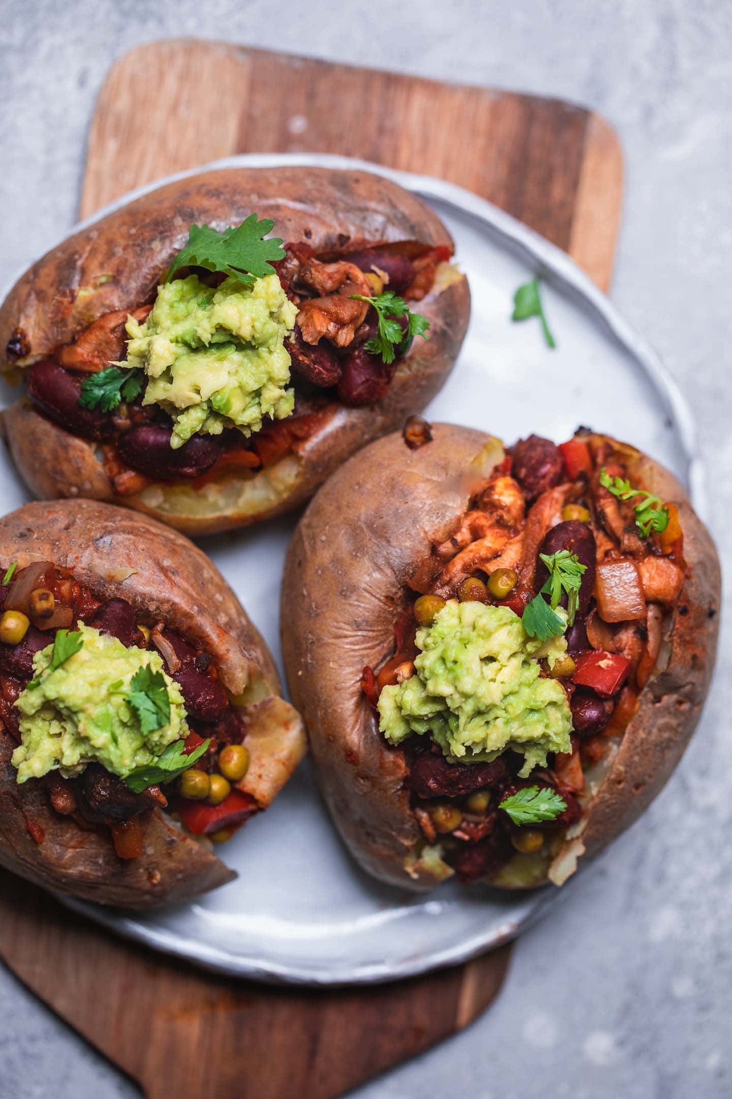 Baked potatoes with kidney beans and mashed avocado