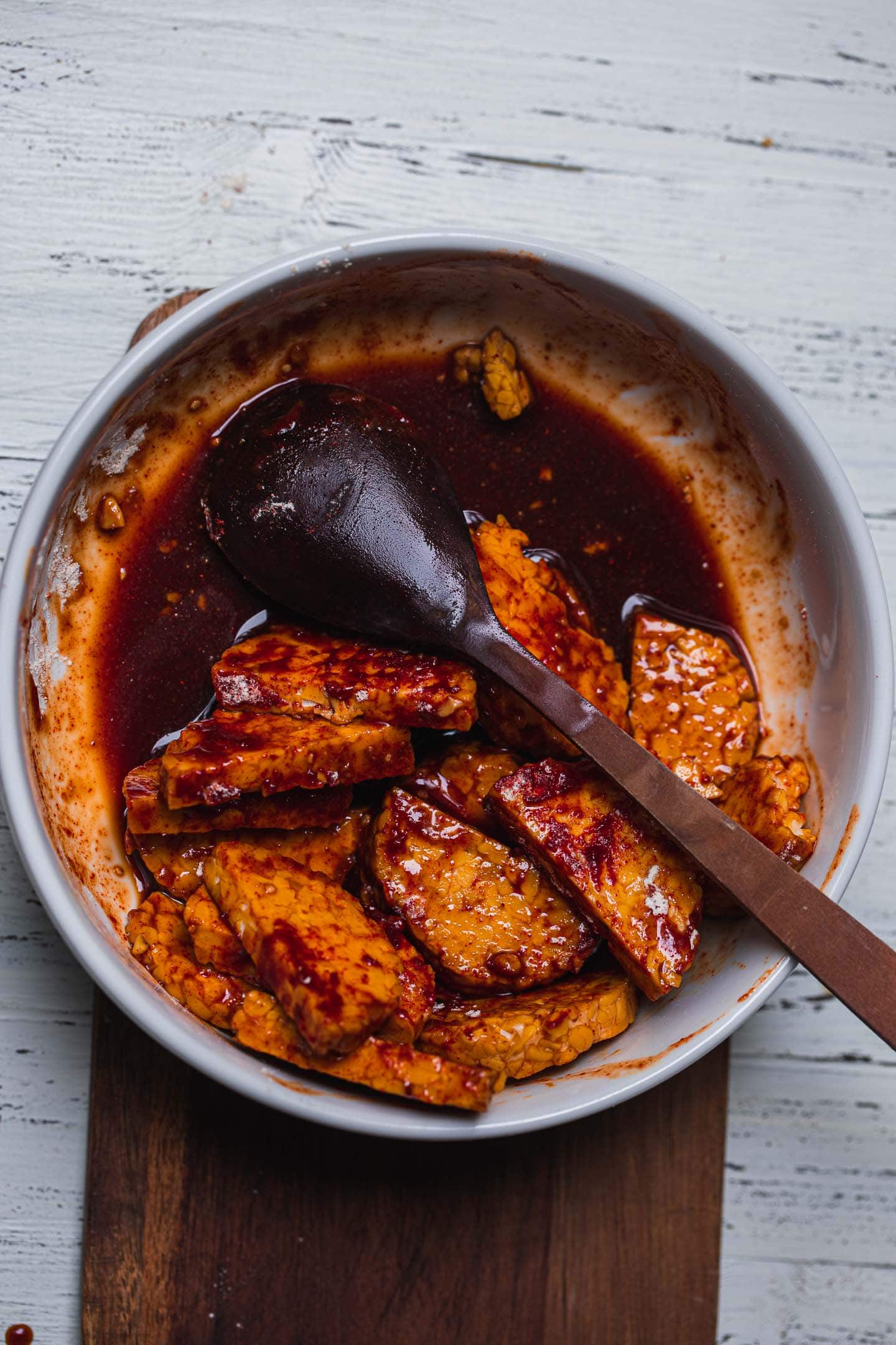 Tempeh in a smoky sauce in a mixing bowl