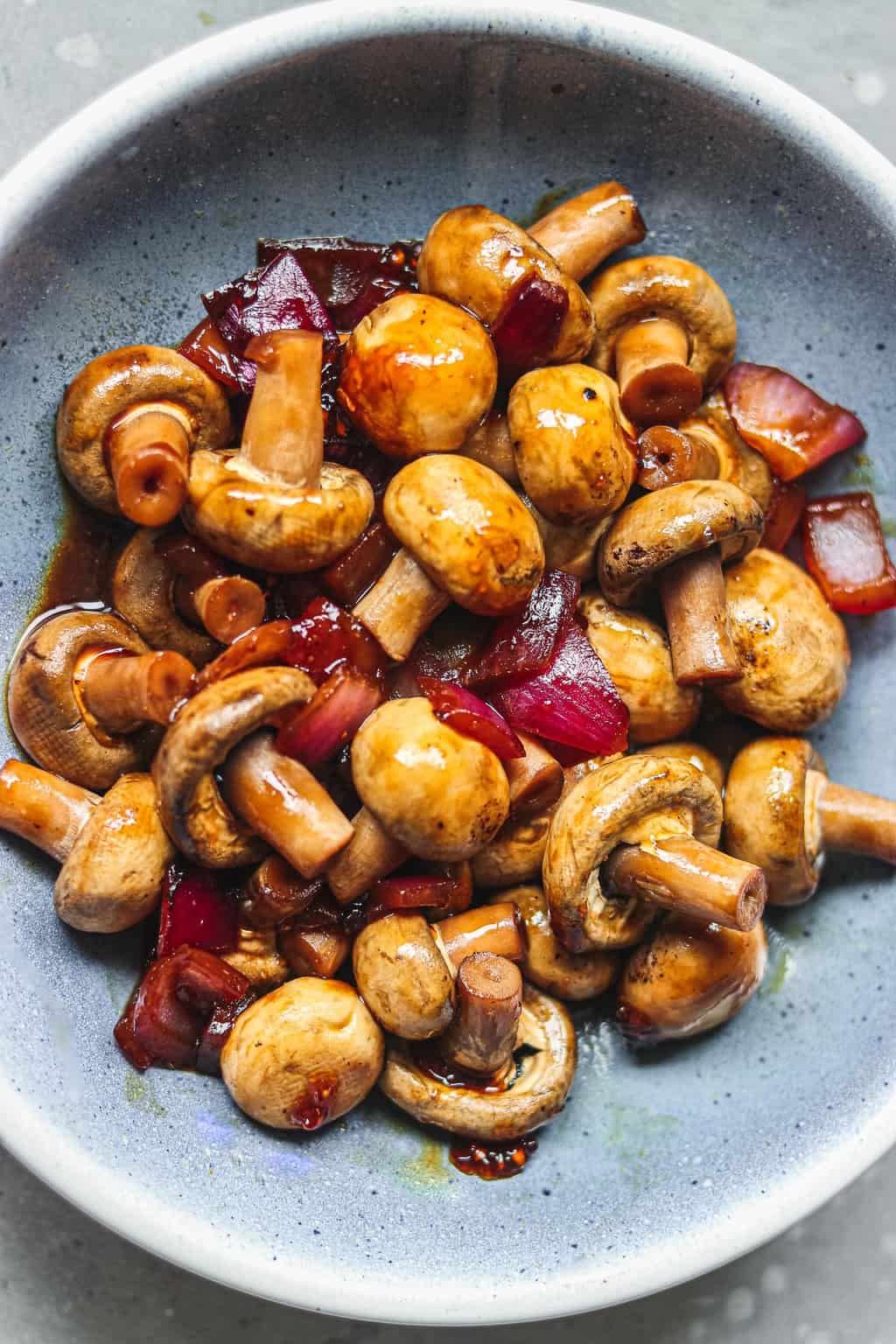 Mushrooms in a blue bowl with a miso glaze