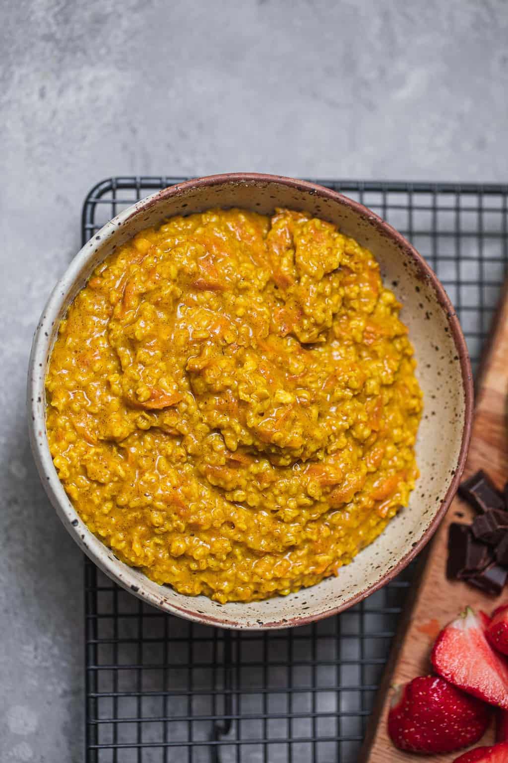Orange porridge in a bowl on a cooling rack