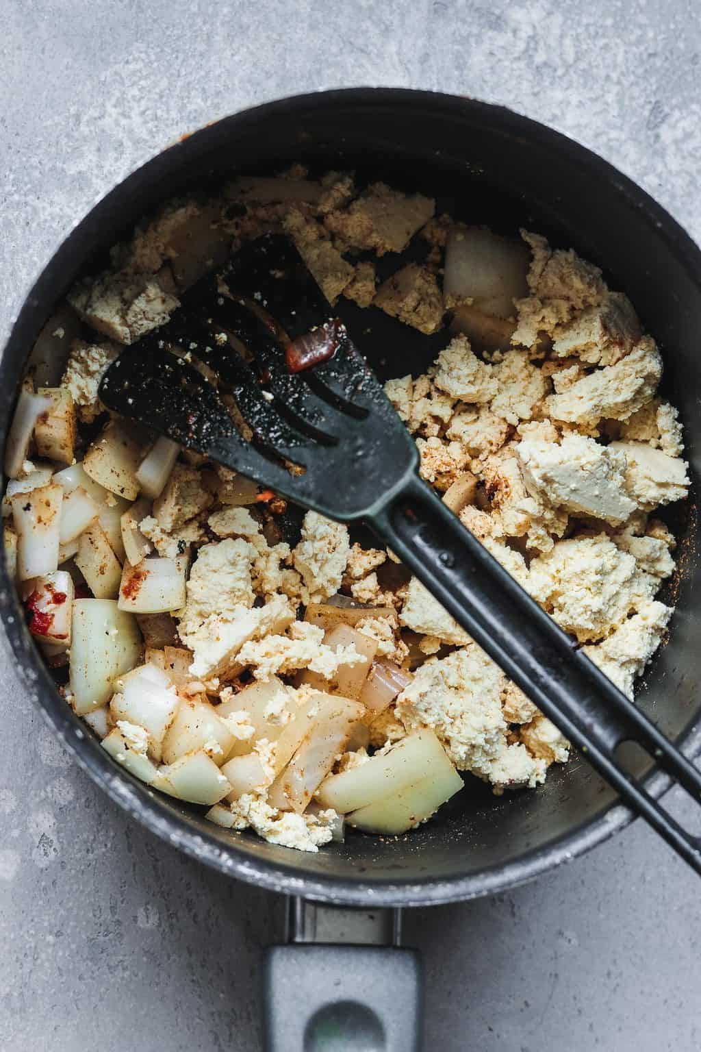 Tofu and onion in a saucepan