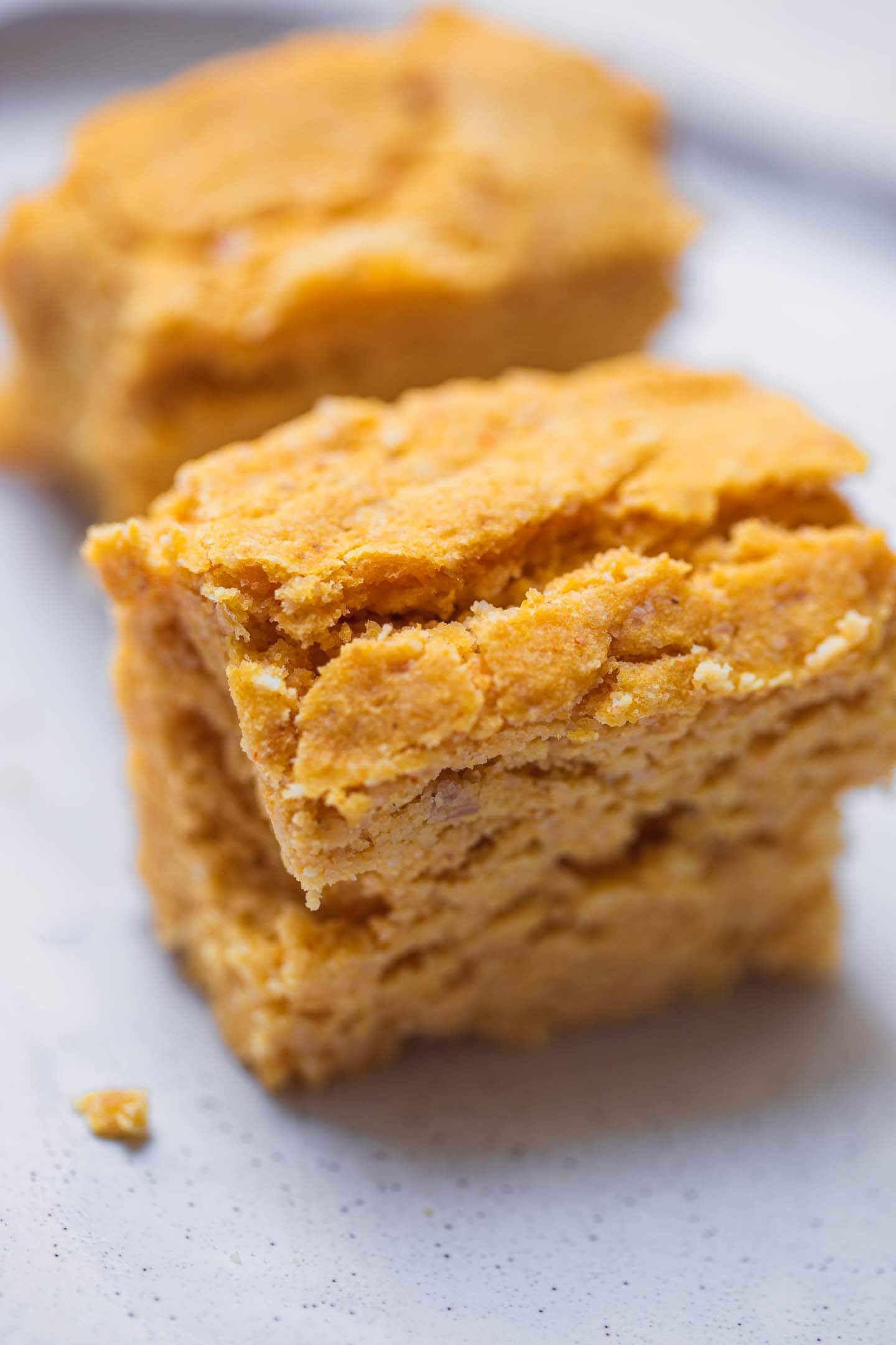 Two slices of cornbread on a plate