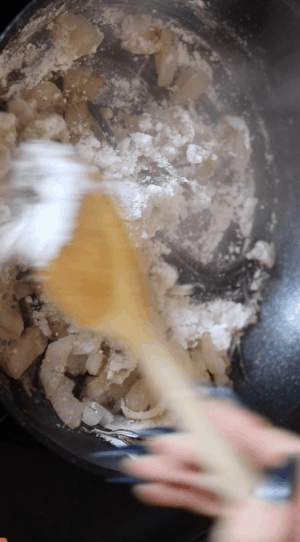 Onion and flour in a frying pan