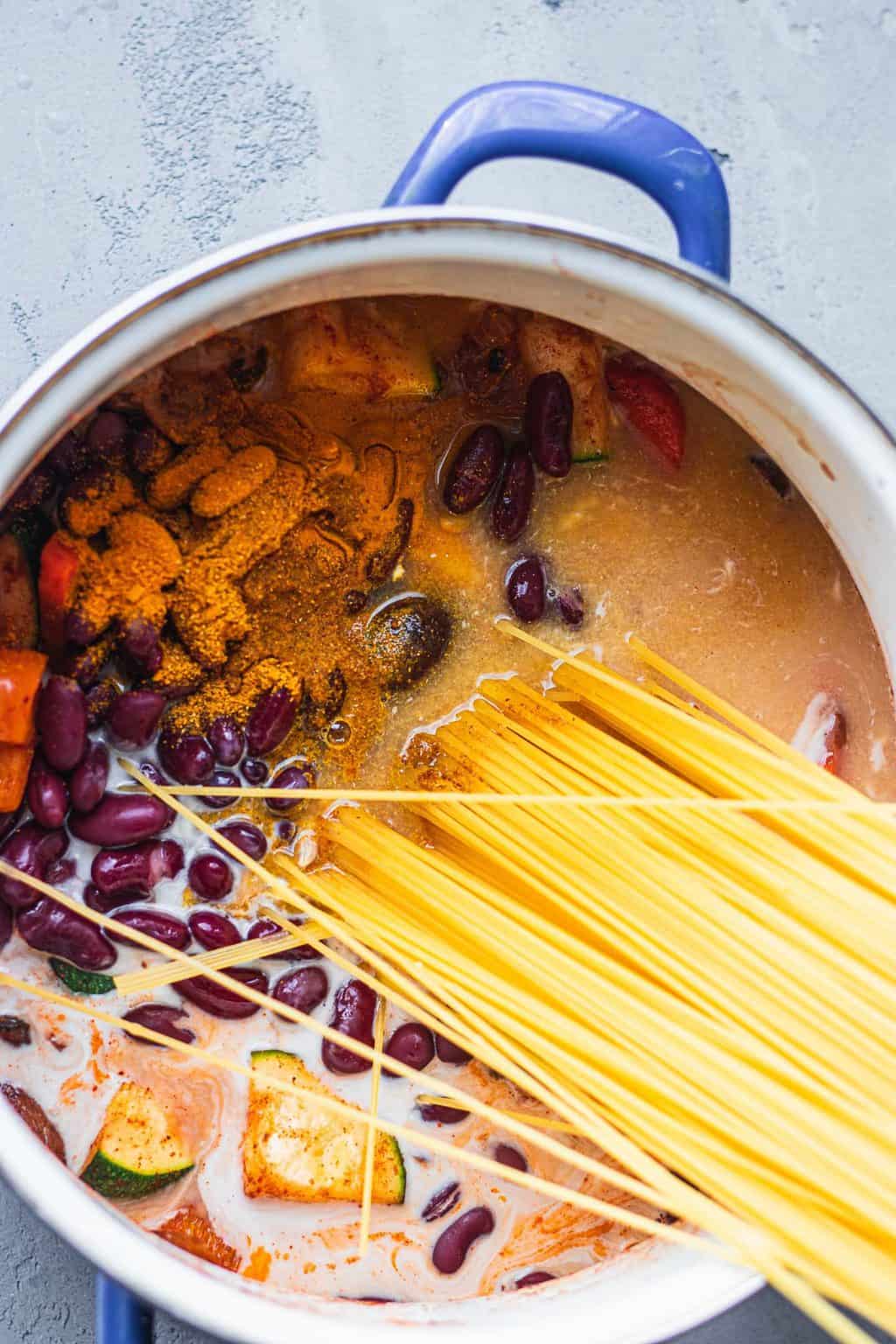 Spaghetti in a saucepan with kidney beans