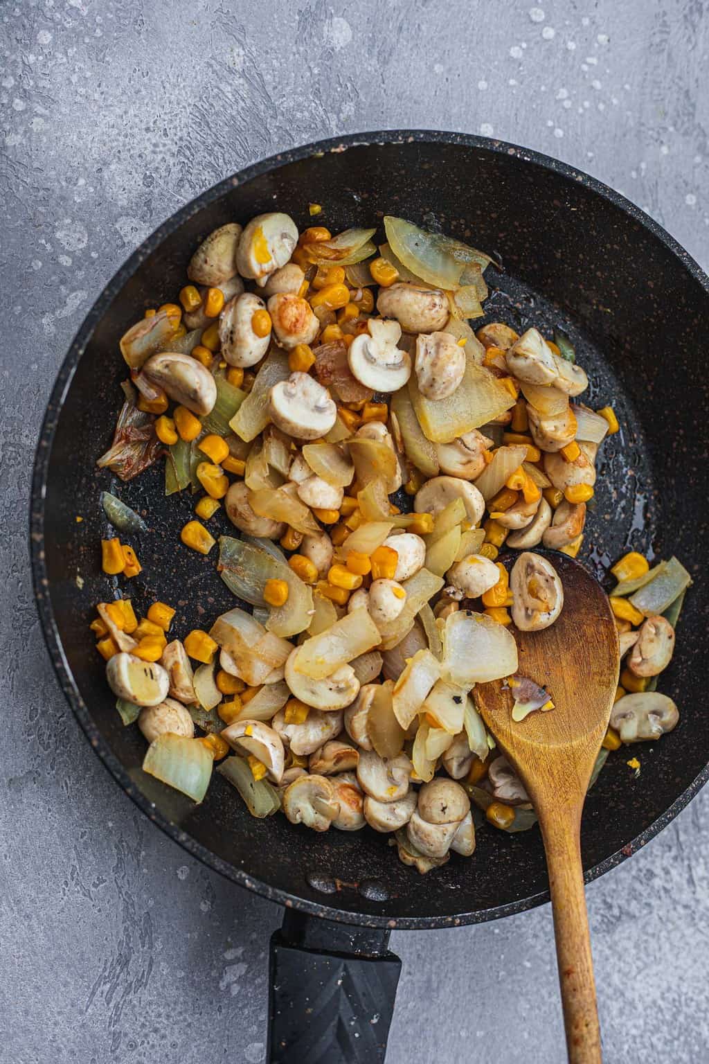 Frying pan with sautéd onions mushrooms and sweetcorn