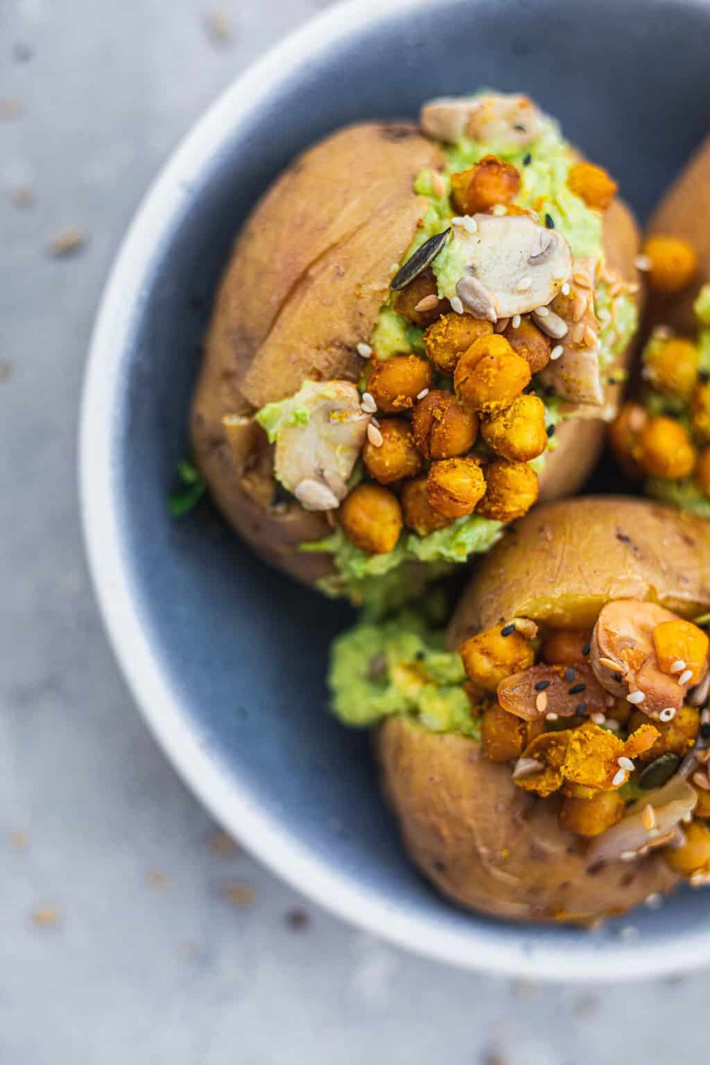 Closeup of vegan baked potato with chickpeas and avocado