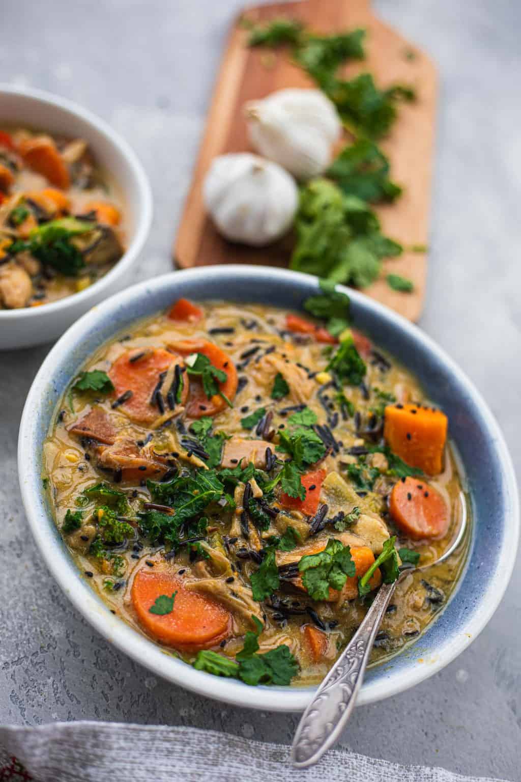 Closeup of blue bowl with vegan vegetable and jackfruit soup