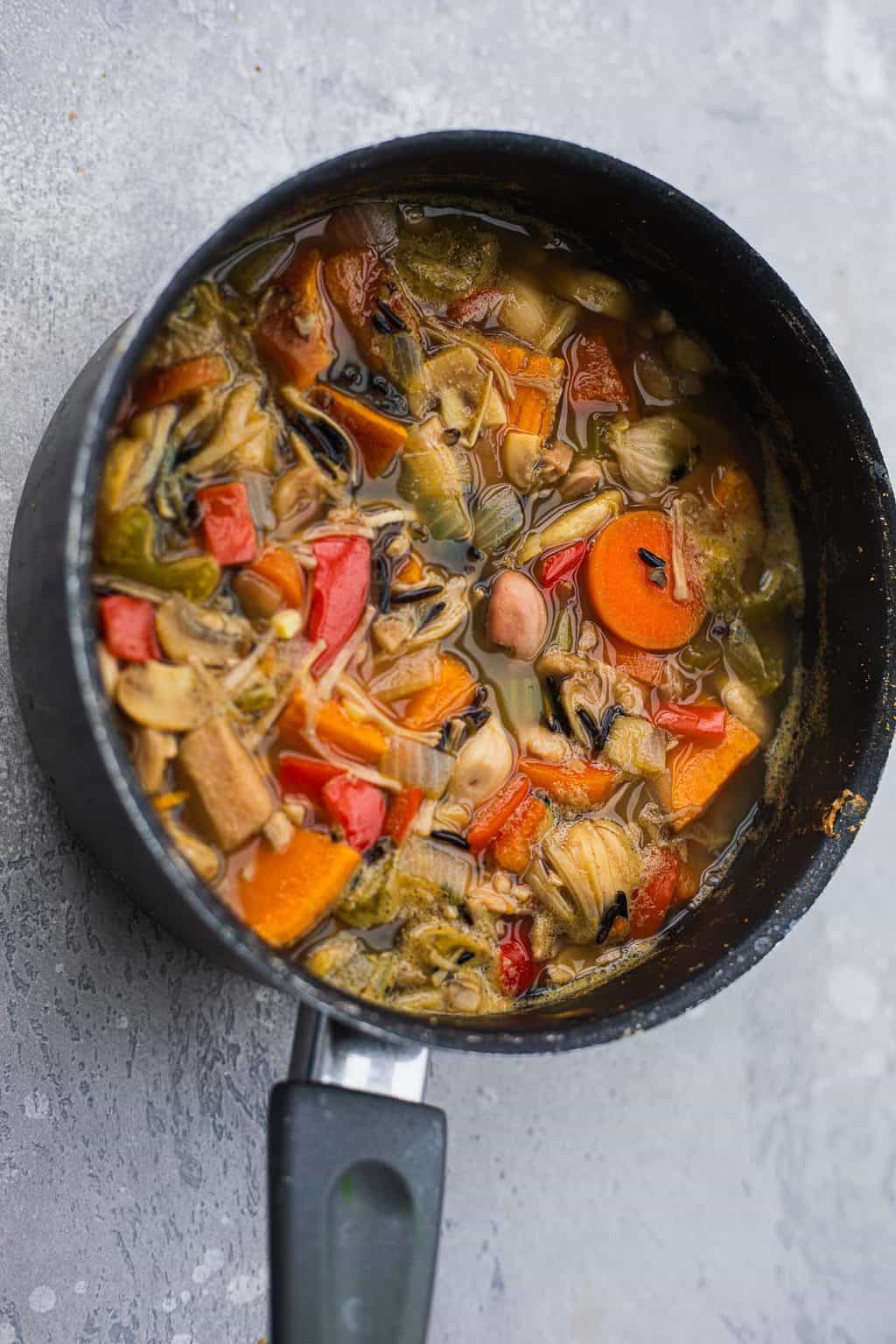 Vegan rice and vegetable soup in a saucepan