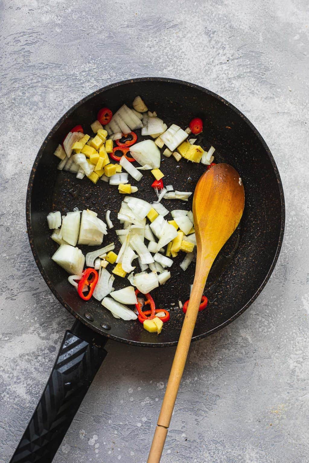 Onions, garlic, ginger and chillies in a frying pan
