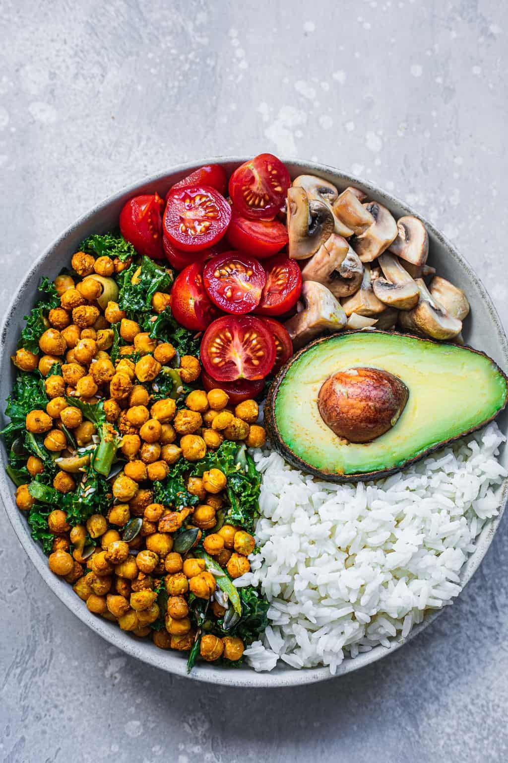Bowl with vegan kale salad, rice and mushrooms