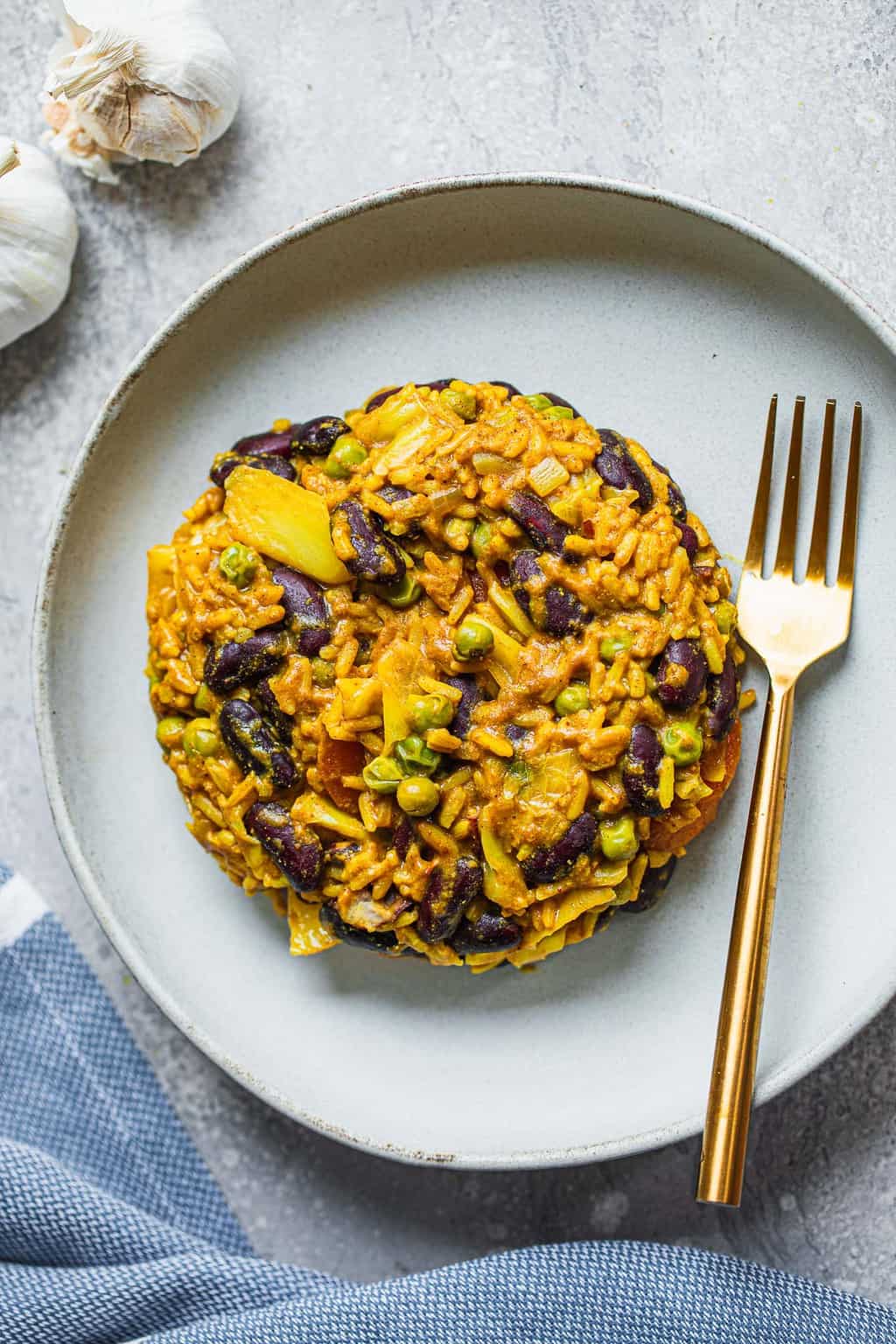 Curried rice and beans on a white plate