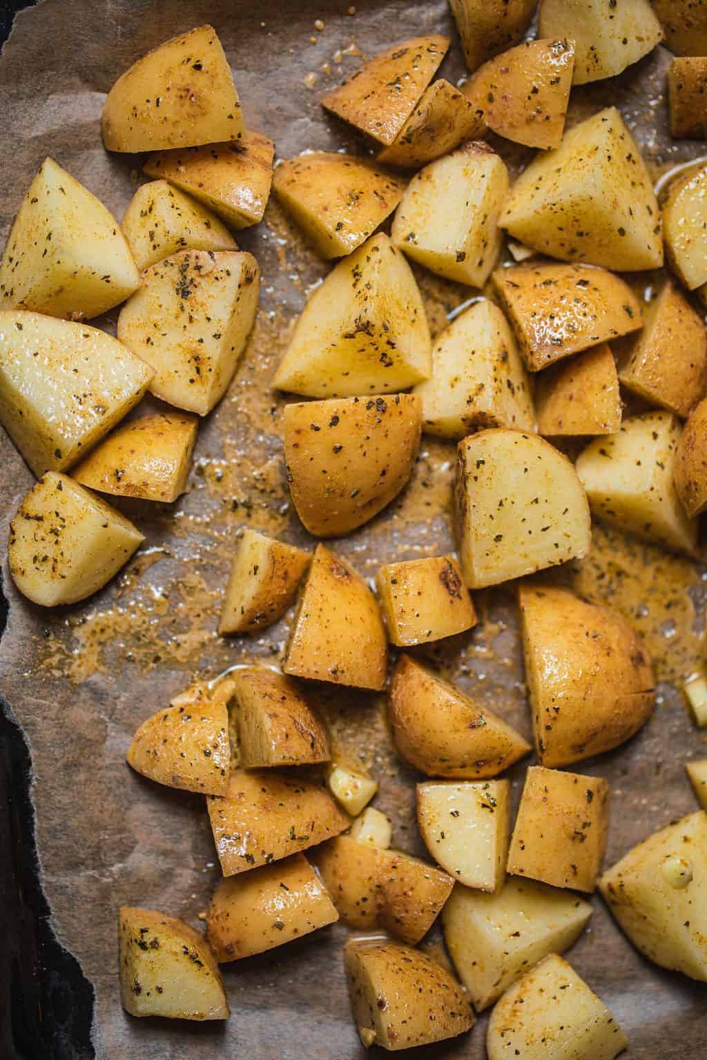 Potatoes on baking paper before baking