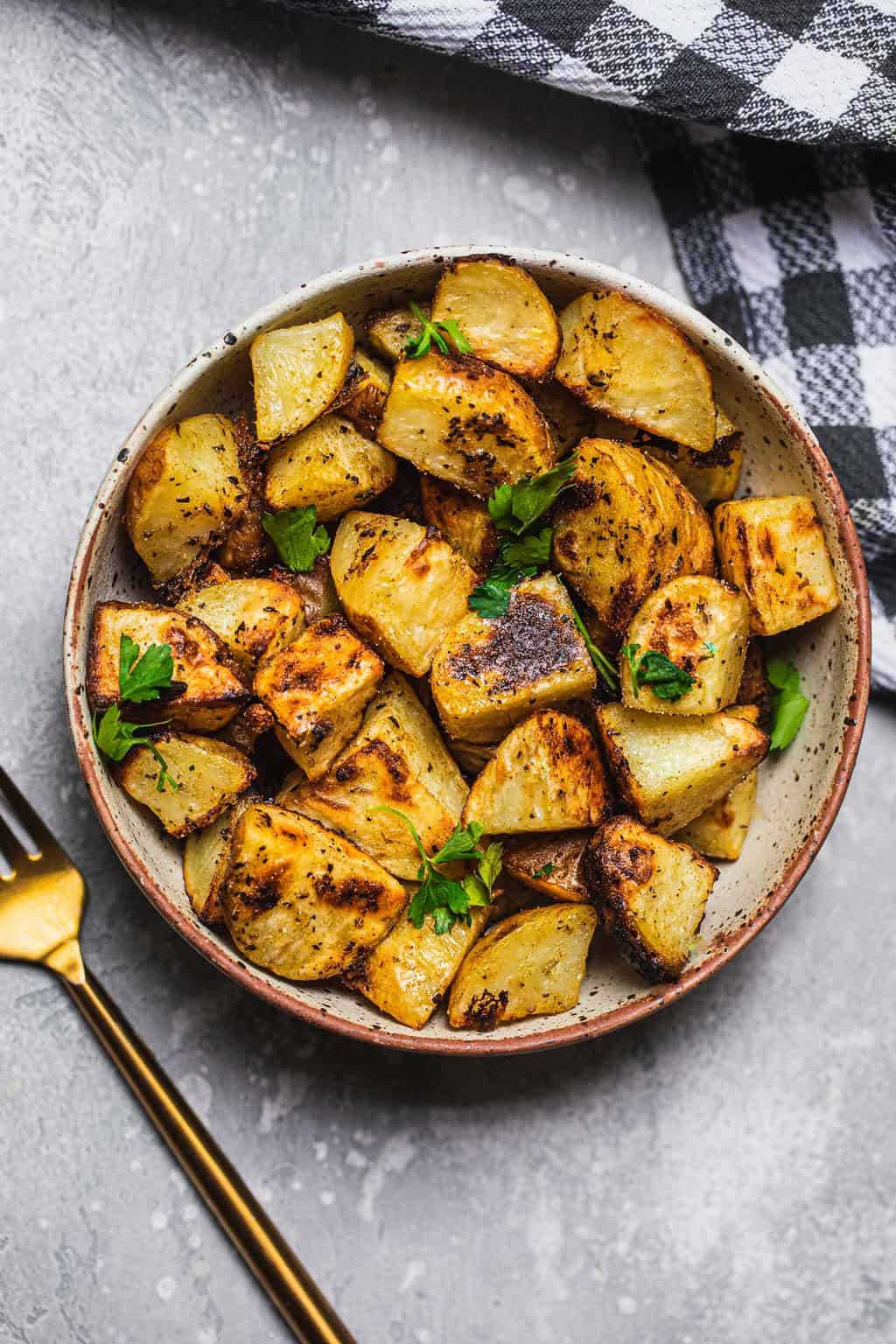 White bowl with lemon potatoes and corinader