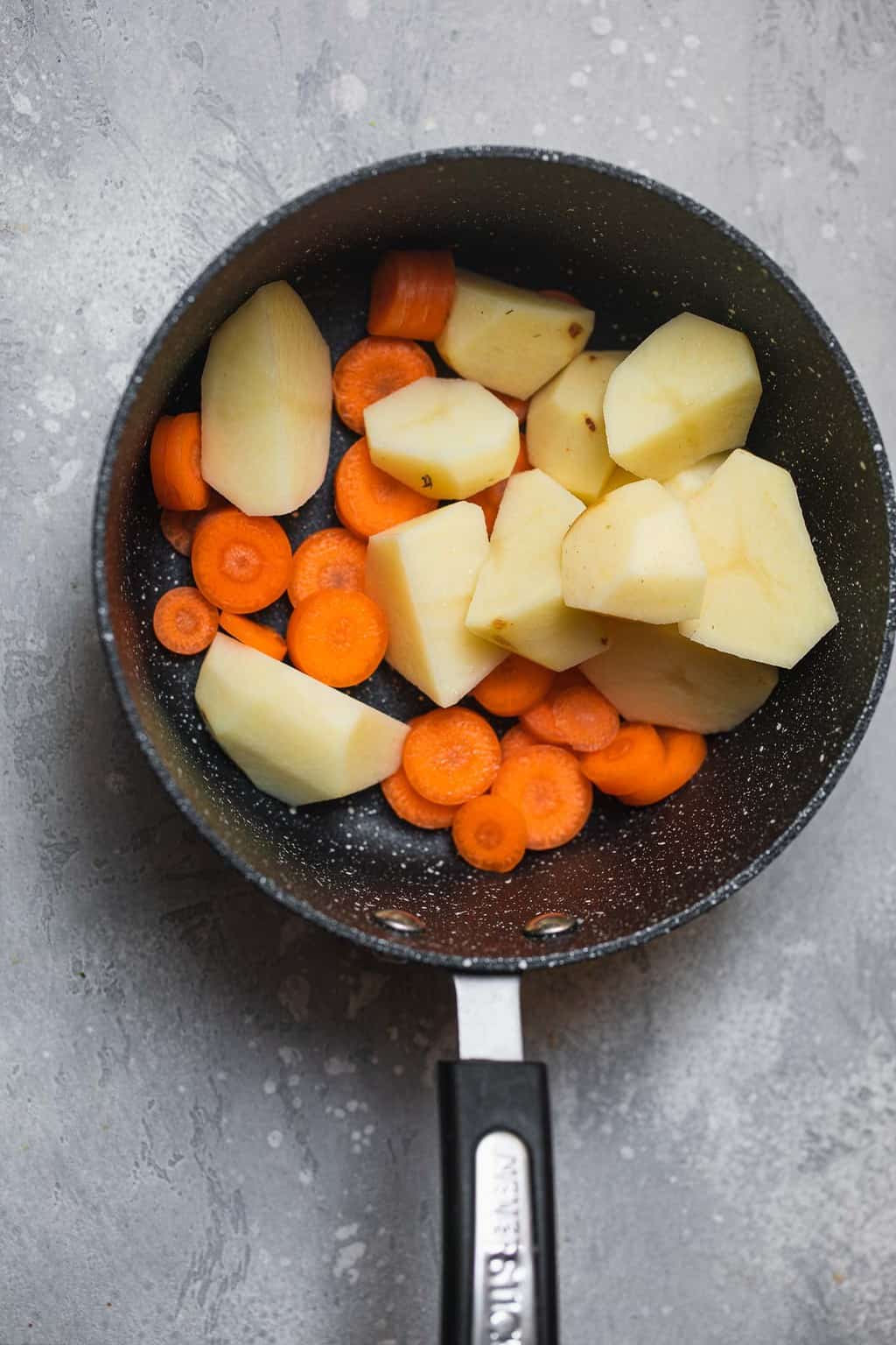 Carrots and potatoes in a saucepan