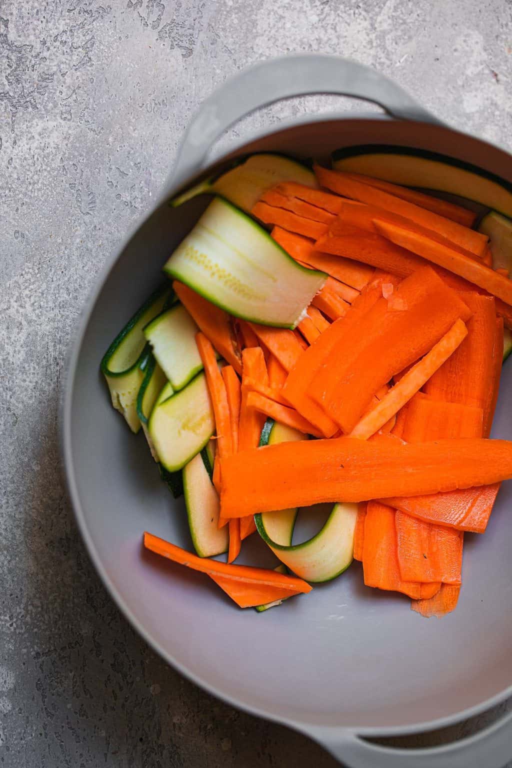 Zucchini carrots sweet potato in a mixing bowl