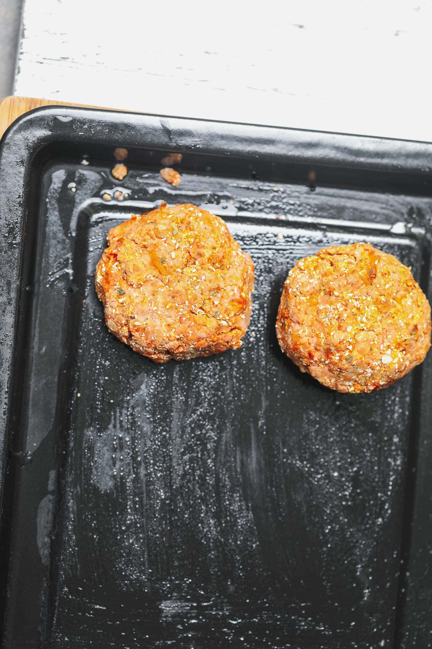 Veggie burgers on a baking tray before cooking