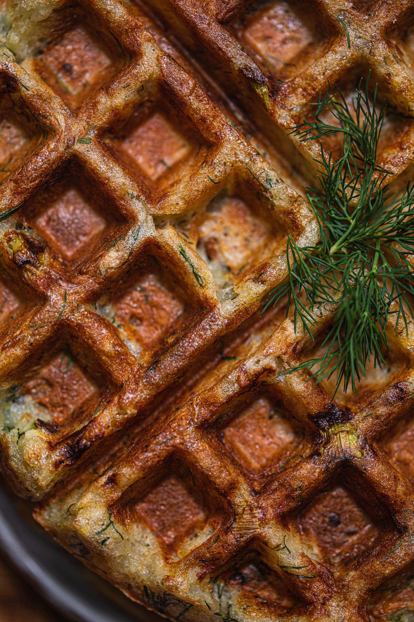Closeup of potato waffles with dill on top