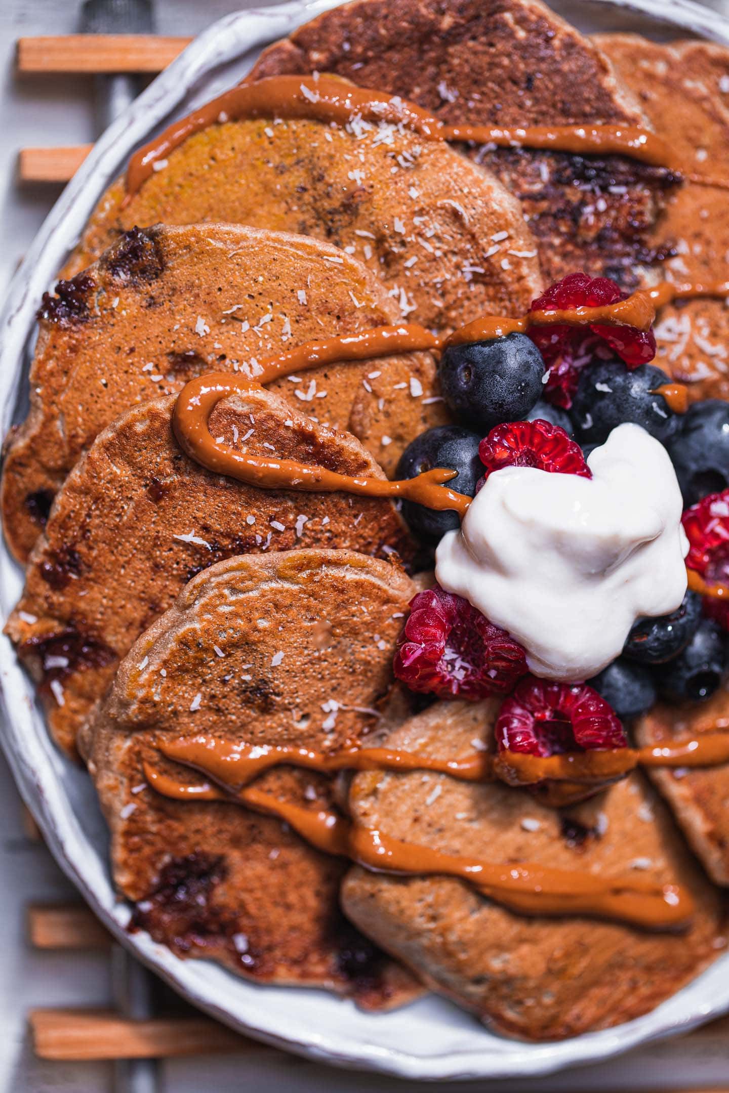 Closeup of a plate with chocolate chip pancakes and berries