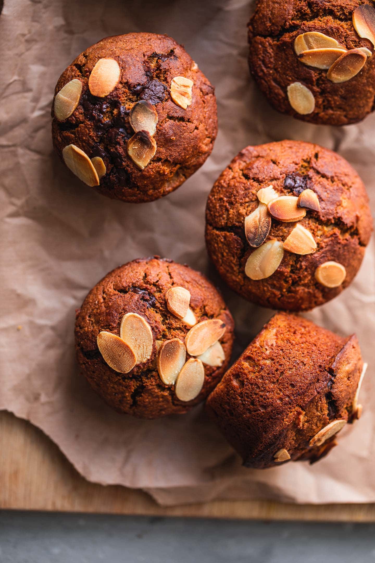 Closeup of muffins with almonds on a wooden board