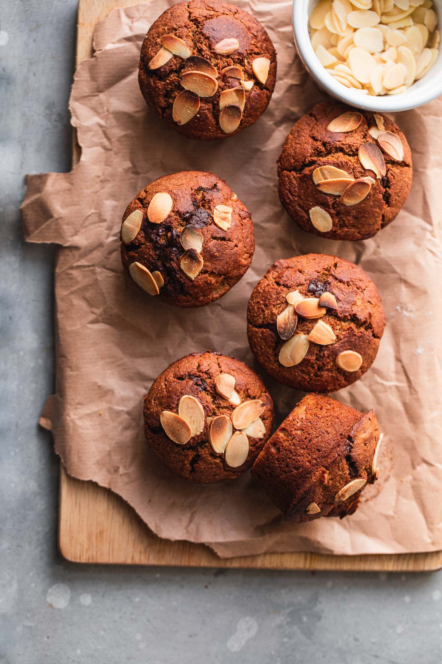 Vegan muffins with almonds on a wooden board