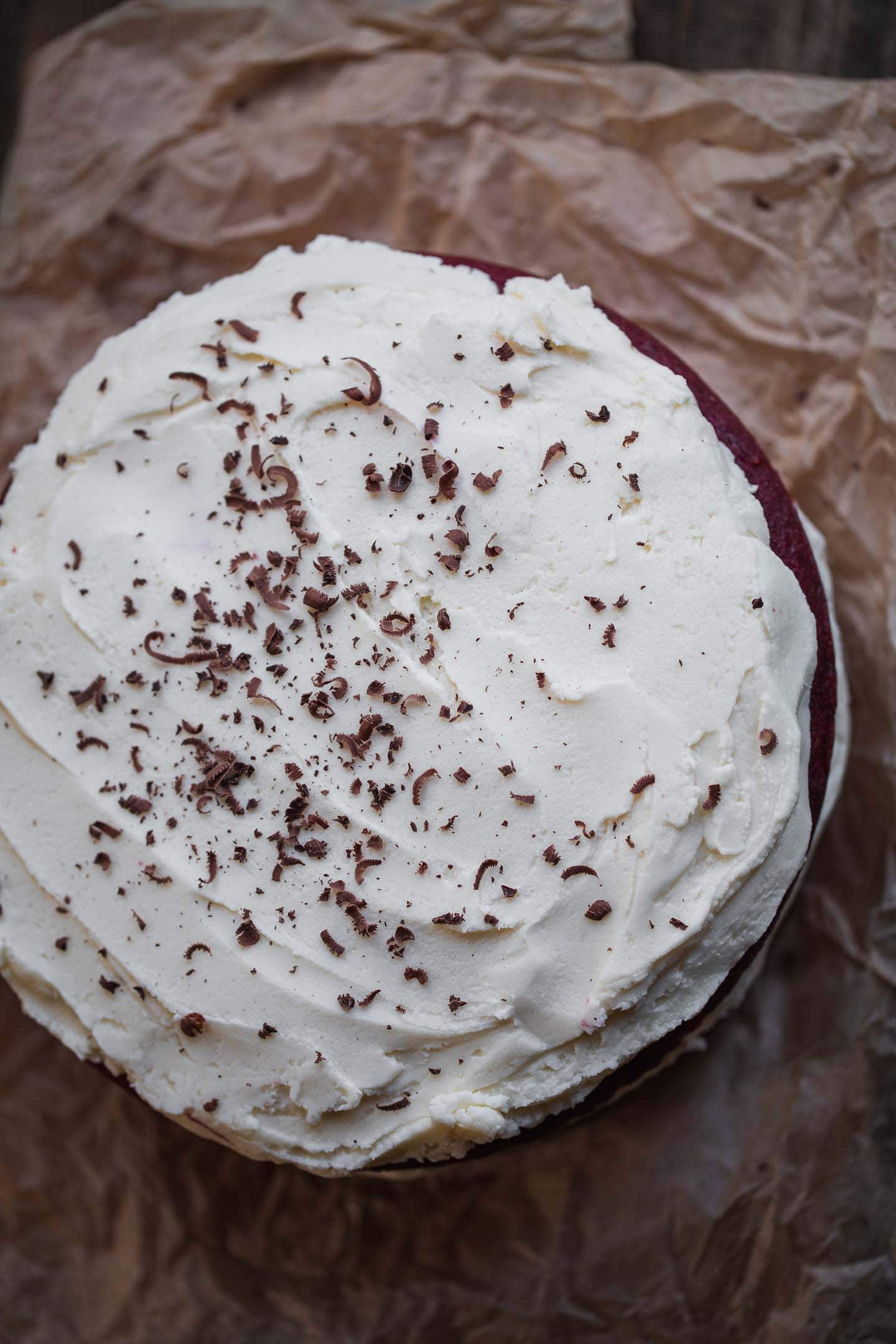 Frosted vegan red vegan cake on a wooden board