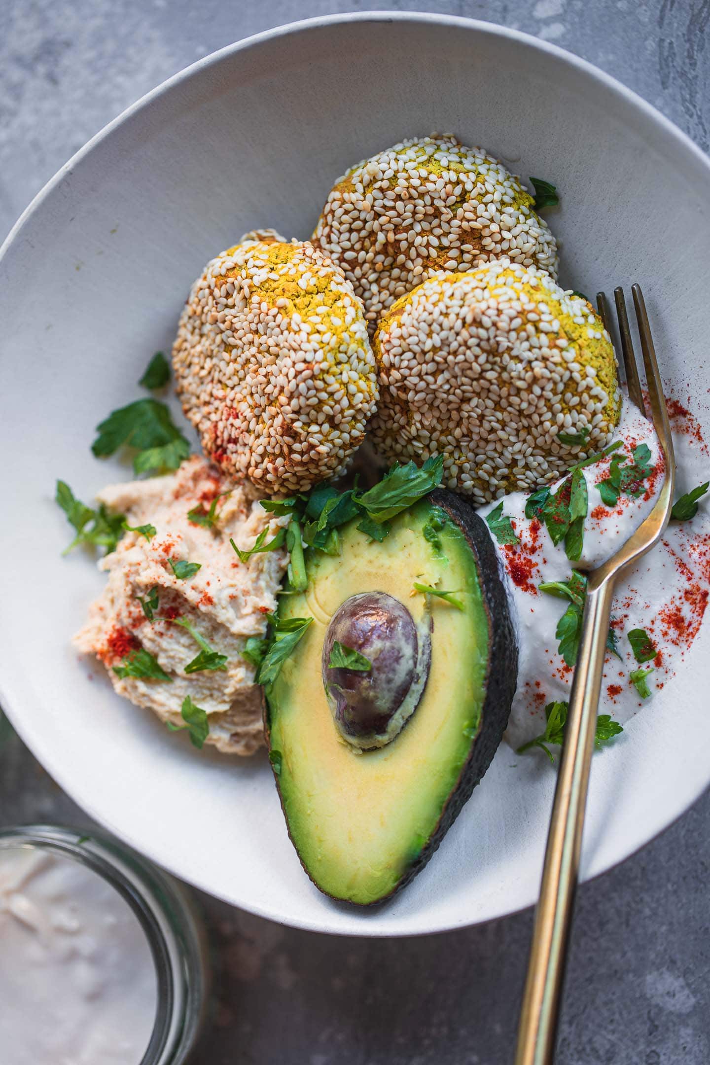 Bowl with vegan falafel, avocado, hummus and soy yoghurt