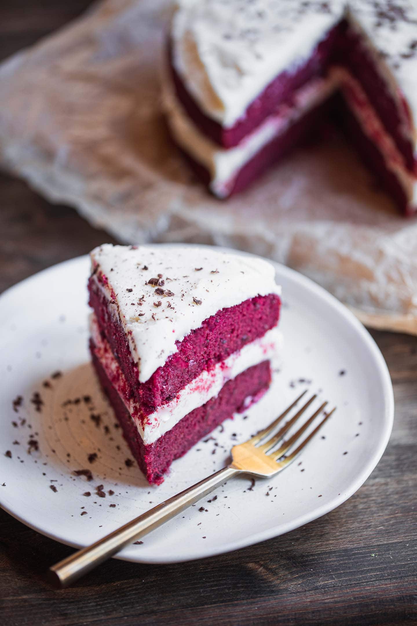 Red velvet cake with frosting on a plate