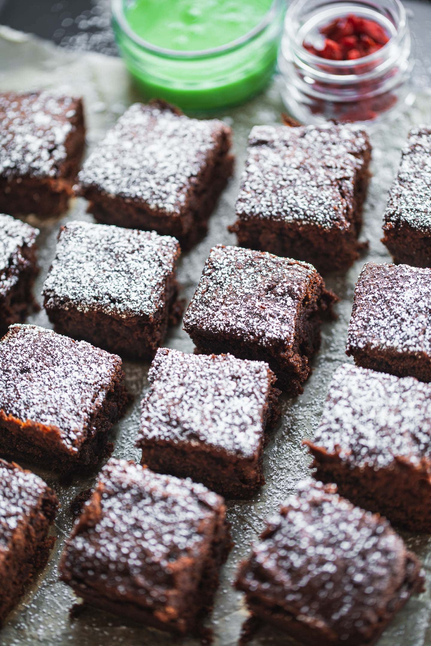 Vegan brownies on a baking tray with peppermint icing