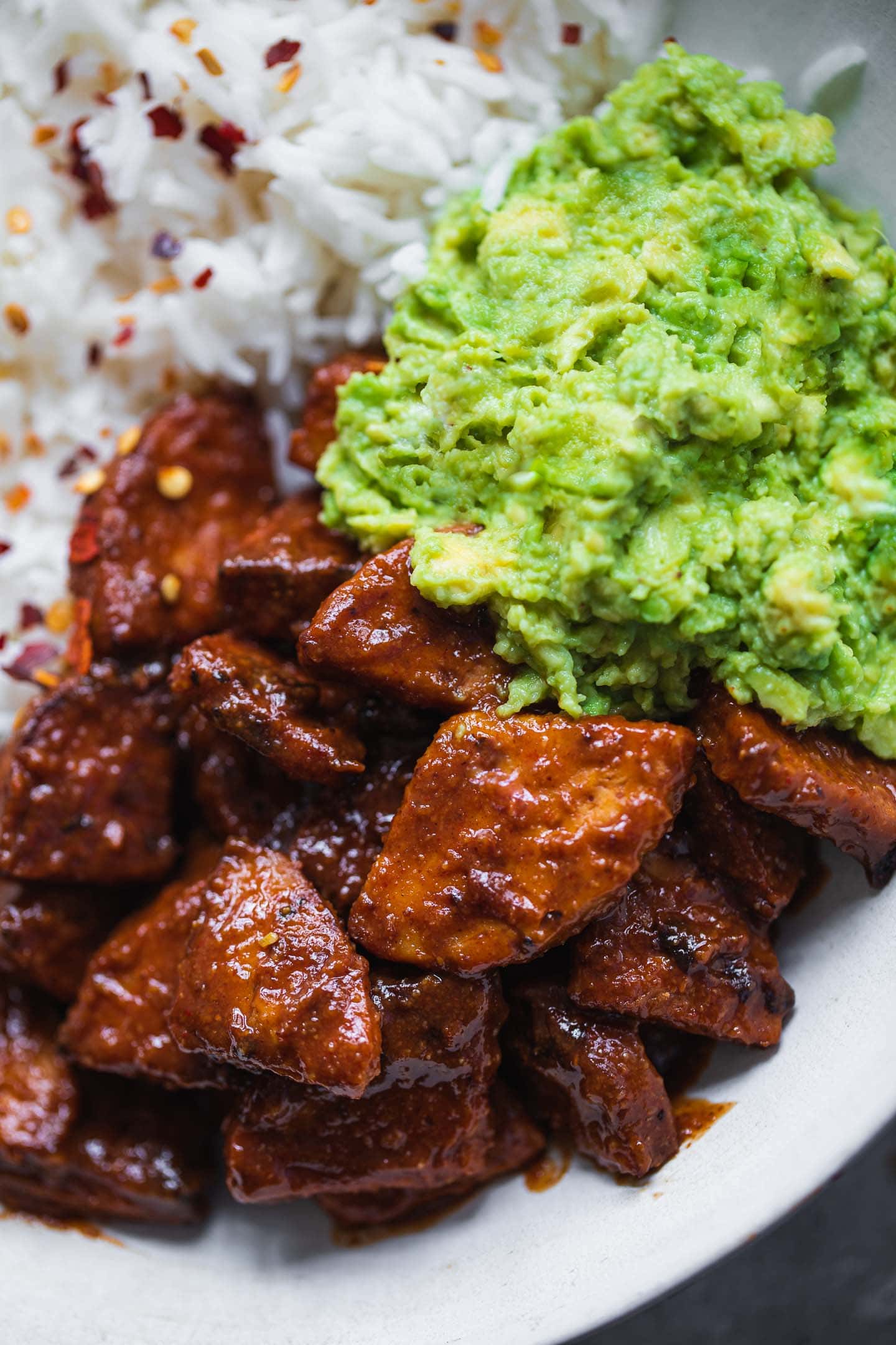 Closeup of baked BBQ tempeh in a bowl