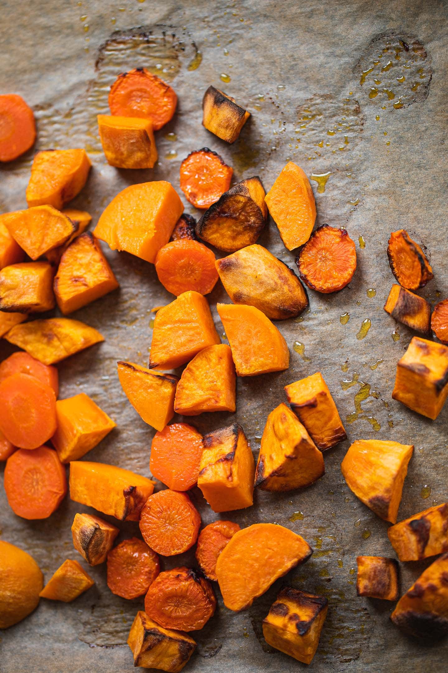 Roasted sweet potato and carrots on a baking tray