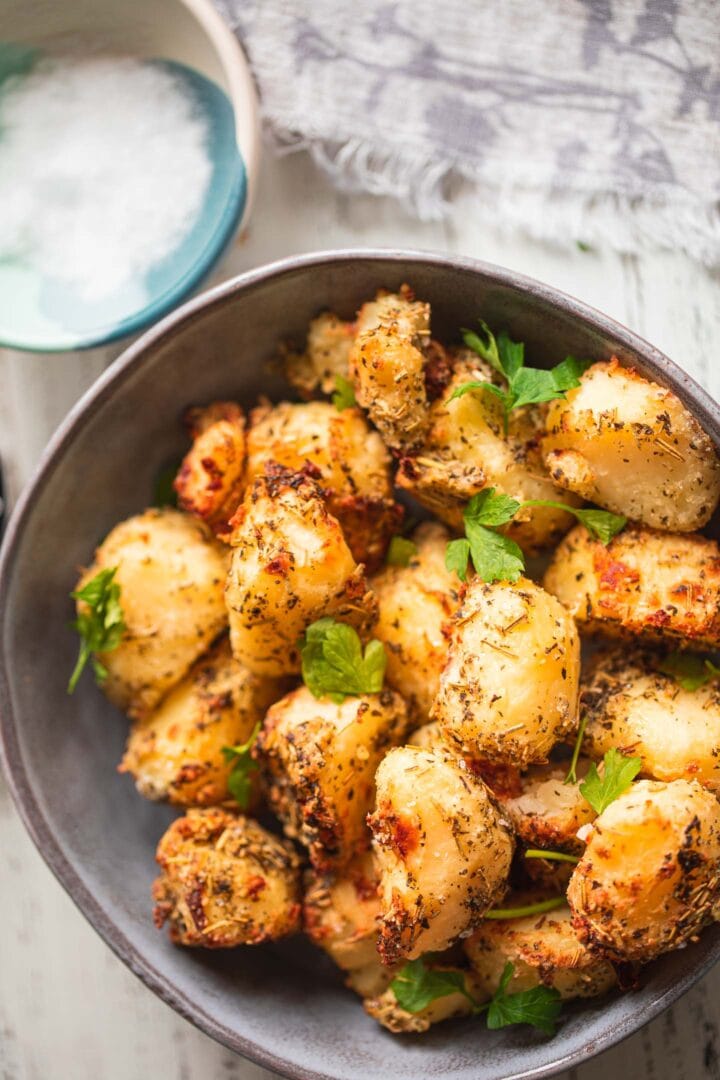 Bowl of crispy potatoes with herbs