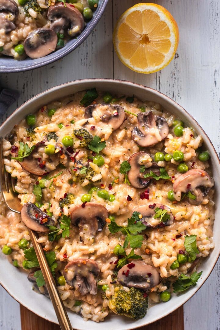 Bowl of vegan risotto with mushrooms and broccoli