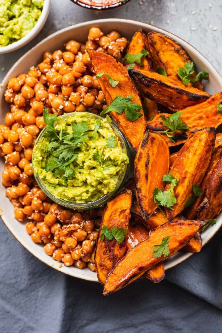 Bowl with crispy sweet potato wedges and sesame chickpeas