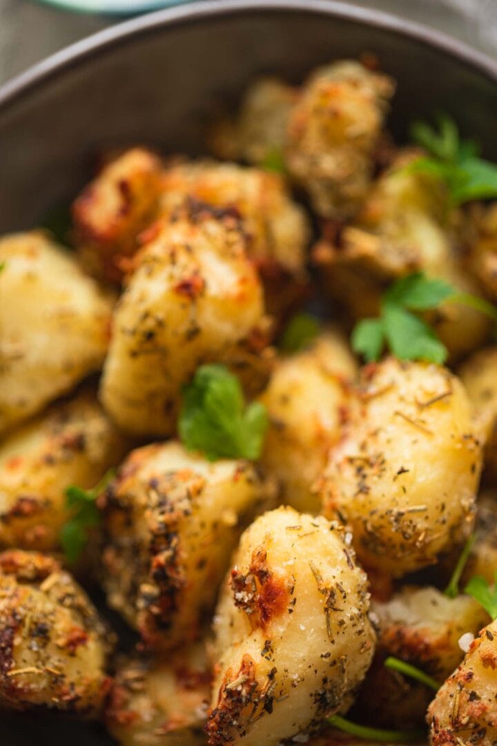 Closeup of roast potatoes with herbs