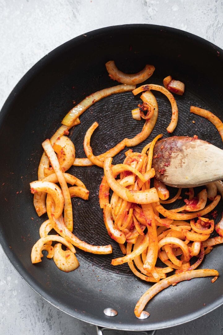 Cooked onions in a frying pan