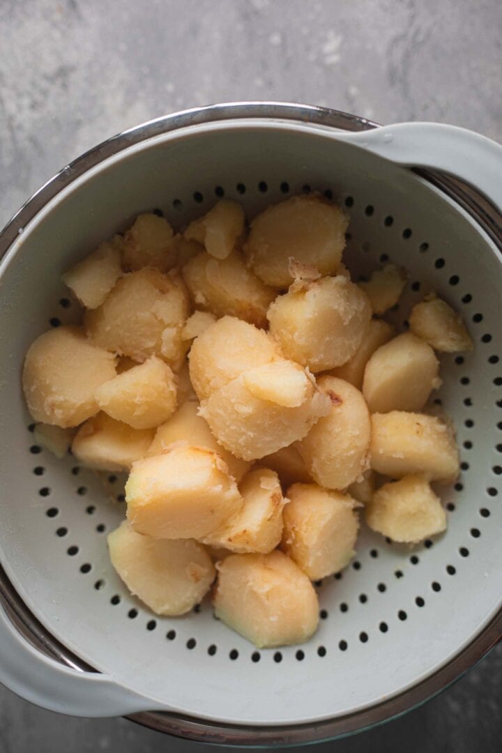 Parboiled potatoes in a colander