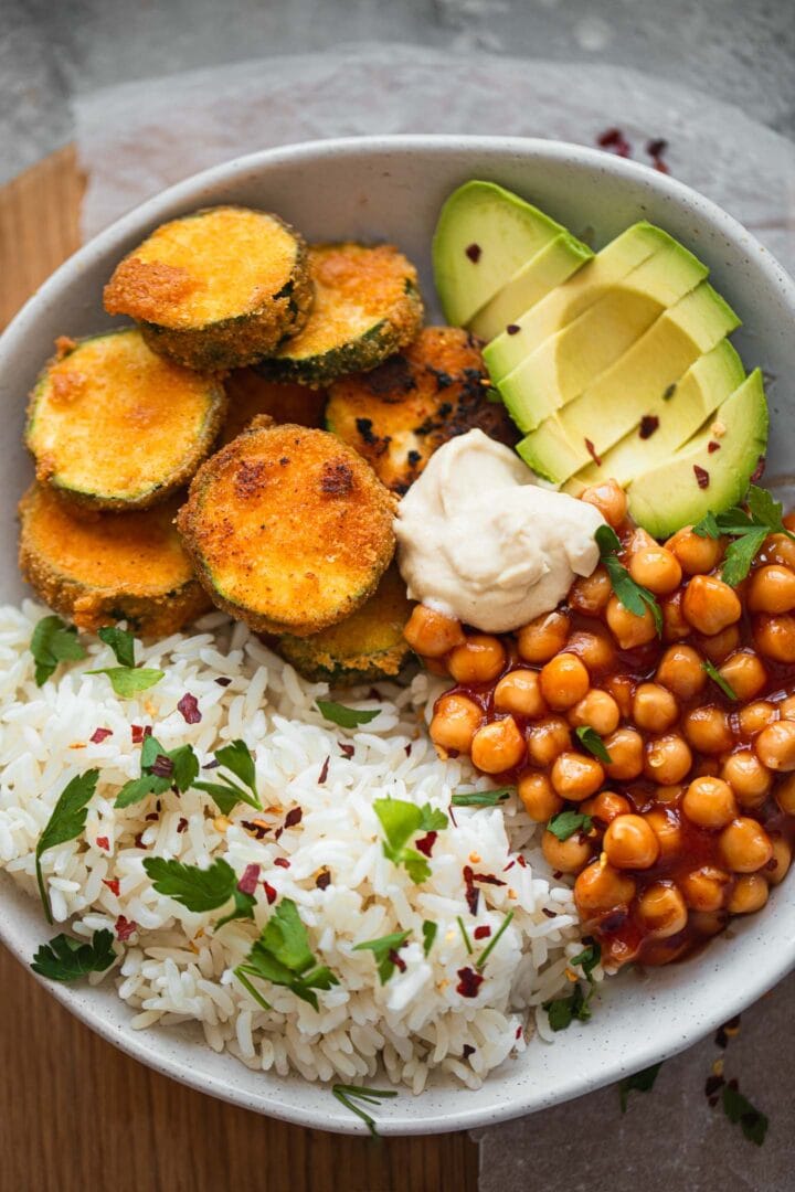Bowl with fried zucchini, avocado, chickpeas and rice